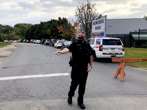 Brockville Police Special Constable Andrew Walford-Davis turns a motorist away as the lineup for the Memorial Centre COVID-19 testing site is full early on the morning of Sept. 23. (FILE PHOTO)