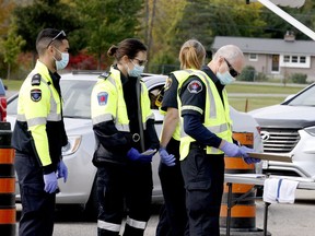 Leeds and Grenville paramedics and student volunteers prepare to deal with a lineup of people seeking a COVID-19 test, at Centre 76 in Athens on Friday, Sept. 25. (RONALD ZAJAC/The Recorder and Times)