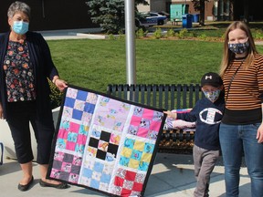 Max Nuttall, 5, and mom Samantha Campbell, with the quilt made by Marjorie Neill (left) that he selected on Saturday. Photo on Saturday, September 26, 2020, in Cornwall, Ont. Todd Hambleton/Cornwall Standard-Freeholder/Postmedia Network