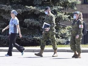 A staff member escorts members of the Canadian Armed Forces into a long-term care home in Pickering back in April.