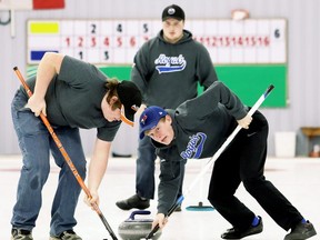 Ridgetown Royals second Adam Van Maanen, right, and lead Colin Scott sweep as vice Brady Sheets watches during the LKSSAA boys' curling final at the Golden Acres Curling Club in Blenheim, Ont., on Wednesday, March 1, 2017. Simon VanWetten skipped Ridgetown to an 11-7 win over St. Patrick's. Mark Malone/Chatham Daily News/Postmedia Network