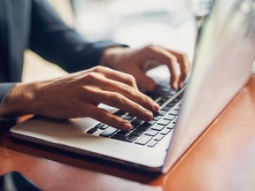 Close up of a hands of a businessman on a keyboard.