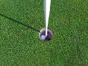 Golf ball and Flagstick of  Manicured grass of putting green