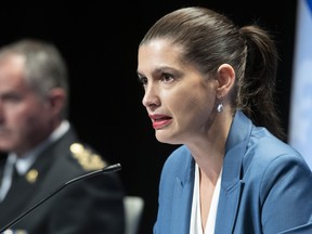 Quebec Deputy Premier and Public Security Minister Genevieve Guilbault during a news conference on the COVID-19 pandemic, Friday, September 18, 2020 in Quebec City. Guilbault announced interventions by police forces across the province. Quebec City police director Robert Pigeon, left, looks on. THE CANADIAN PRESS/Jacques Boissinot