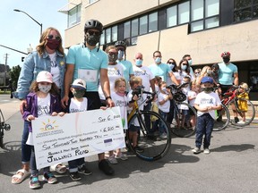 Jillian and Jordane Verner and the supporters of the Jillian's Road fundraiser presented a ceremonial cheque for $6,210 to the University Hospitals Kingston Foundation after Jordane and friends cycled 105 kilometres from Prince Edward County to Kingston on Sunday. (Meghan Balogh/The Whig-Standard)