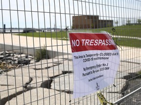 The City of Kingston fenced off access to the Gord Edgar Downie Pier and the Breakwater Park beach on Saturday morning after amending an emergency order to close the public spaces due to COVID-19 concerns. (Meghan Balogh/The Whig-Standard)