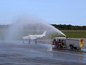 A FlyGTA airplane receives a traditional welcome from Kingston Fire and Rescue for a new arrival in Kingston on Thursday. (Elliot Ferguson/The Whig-Standard)