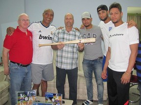 Herardo Hernandez, a member of the Cuban 5, holds a Cubacan "trophy" bat while surrounded by members of Cuba's first family of baseball, the Gurriels, and bat maker Bill Ryan. From left are Ryan, Lourdes Gurriel Sr., Hernandez, ex-Baltimore Oriole Yuniesky Gurriel, current Toronto Blue Jay Lourdes Gurriel Jr. and Houston Astro Yuliesky Gurriel. (Supplied Photo)