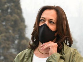 U.S. Democratic vice-presidential nominee and senator from California Kamala Harris adjusts her face mask on a visit with California Gov. Gavin Newsom to view fire-ravaged property from the Creek Fire near Pine Ridge Elementary School, where they met with firefighters in Fresno, Calif., on Tuesday. (Frederic J. Brown/Getty Images)