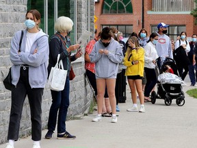 People lined up outside the COVID-19 assessment centre at the Leon's Centre in Kingston last Tuesday. (Ian MacAlpine/The Whig-Standard)