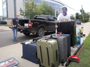 Nigel Smith, foreground, of Minden gets some help from his father, Richard, to move into Victoria Hall during the first of five move-in days for Queen's University first-year students on Tuesday. (Ian MacAlpine/The Whig-Standard)