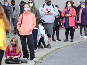 Hundreds of people including many children wait to get tested for COVID-19 outside of the testing centre at the Leon's Centre on Tuesday September 22, 2020.