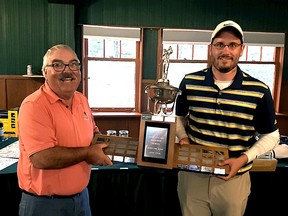 Kirkland Lake Golf Club President Jacques Seguin presents Alex Dube of Rouyn-Noranda with the Lakeshore Motors Labour Day Tournament championship trophy.