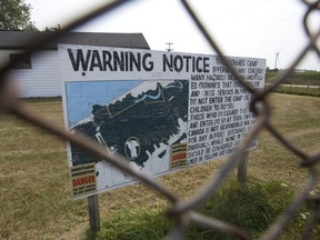 A sign pictured in 2015 warns visitors to the former army camp at the Chippewas of Kettle and Stony Point First Nation of unexploded ordnance in parts of the 971-hectare site. It's estimated it'll take another 25 years to clear, a Department of National Defence spokesperson says.