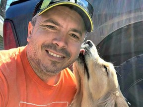 Teigan Martel receives a kiss from his dog. The former North Bay paramedic is sharing his story in hopes that others suffering in silence will seek the help they need. Submitted Photo