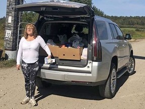 Bonfield Event Park owner Lisa Groves stands beside a van loaded with canned goods donated by drag race teams and spectators during the operationÕs first race event this past weekend. Supplied Photo