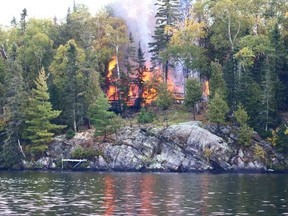 Fire destroys the Drenth family cottage on Trout Lake’s Hemlock Island, Monday.
 Jason McKnight photo