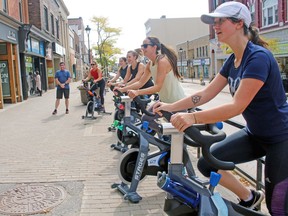 Students get a quick session, Friday, on the bikes that will be part of REVolve in North Bay on Main Street. The studio is expected to open next month. PJ Wilson/The Nugget
