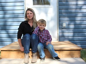 Jamie and Jayce Gagnon on the front steps of their new home, which Jamie is buying through Habitat for Humanity Melfort. Photo Susan McNeil.