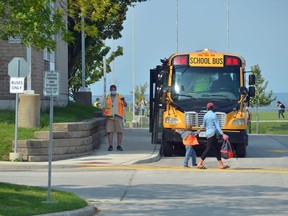 A parent picks up a child as school buses line up at Ecole East Ridge Community School in Owen Sound on Wednesday afternoon.
Rob Gowan/The Sun Times