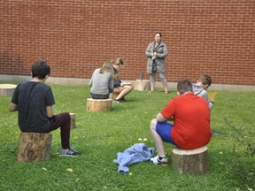 Laurie Otten teaches some of her Grade 7 and 8 students from St. Patrick's in Kinkora on the newly-created outdoor learning area behind the school Sept. 16. Tree stumps donated to the school allow physical distancing and the great outdoors, with plans to create another in front of the school shortly. Having plenty of space allows for students to get outside as much as possible and not have to wear a mask during COVID-19. ANDY BADER/MITCHELL ADVOCATE