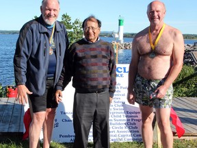 Robert McLaughlin (left) and Glenn Collins completed the Kiwanis Ottawa River COVID Swim at the Pembroke Marina Sept. 5. Upon completion of the 1,500-metre swim they received their medals from Raghavan Vijay (centre), Kiwanis Lieutenant-Governor for Division 13.  Tina Peplinskie