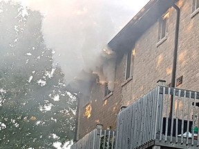 Smoke billows from the window of an apartment on Ivings Drive in Port Elgin on Sept. 20. A man was injured and the fire is under investigation.
(Saugeen Shores 
Police Service photo)