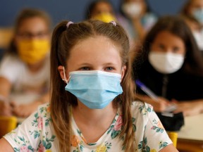 A child wears a mask. REUTERS/Eric Gaillard ORG XMIT: EGA24