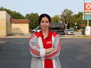 Kathryn Vandenbroek stands near the Circle K as police investigate on Tuesday September 15, 2020 in Petrolia, Ont. Vandenbroek was working the night shift when a masked suspect with a gun demanded cash. Terry Bridge/Sarnia Observer/Postmedia Network