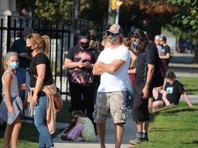 Several people, including students, line up Wednesday at the Twin Bridges Nurse Practitioner-led COVID-19 testing centre in Sarnia. Three student-only testing centres have opened this week. (Paul Morden/Sarnia Observer)