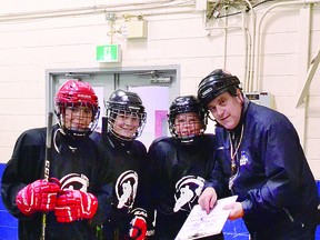 COACH FRANK AND THE BOYS: Players Anthony Spironello, Madden Glavota and Ryan Johnson (left to right) of a Sault Major Hockey Association under 13 cohort group receive instruction from coach Frank Porco prior to a recent on ice skills session. ALLANA PLAUNT/SAULT THIS WEEK
