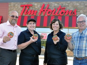 This week, Sept. 14-20, the Tim Hortons Smile Cookie campaign begins, with all proceeds going to the West Perth Village redevelopment project - the first of three consecutive years pledged for the cookie campaign. On hand displaying the product are Tim Hortons owner Mark Moore (left), manager Rita Bedour and Ritz Lutheran Villa board members Shirley Verhoeve and chair David Murray. Their goal this year is $12,000 - so that's 12,000 cookies! Let's get it done!! ANDY BADER/MITCHELL ADVOCATE