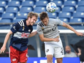 Revolution defender Henry Kessler, left, heads the ball past Impact midfielder Lassi Lappalainen during the first half at Gillette Stadium on Wednesday.