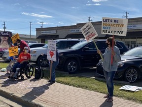 Protesters gathered in front of Searle Turton's office for the second consecutive week Friday.