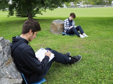 Braedon Bosse, left, and Benji Chaloux participate in a Grade 12 math class outdoors at Ecole secondaire du Sacre-Coeur in Sudbury, Ont. on Tuesday September 8, 2020. John Lappa/Sudbury Star/Postmedia Network