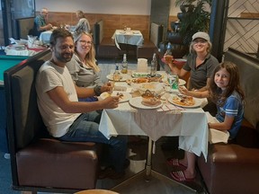 A family enjoys a meal at Espanola's Sukhdev Restaurant & Inn. Supplied photo