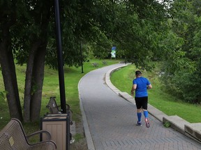 A jogger lopes along the boardwalk at Bell Park. The route remains open despite the new provincial clampdown on activities.