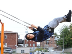 Jaiden Mamakwa soars into the air while swinging  on swings at Queen's Athletic Field in Sudbury, Ont. on Wednesday September 9, 2020.