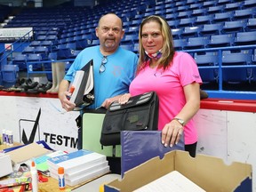 Bob Johnston and Carrie Wasylyk of Tomorrow's Hope, show a selection of school supplies that was handed out to  about 40 families in need at the Sudbury Community Arena in in Sudbury, Ont. on Thursday September 10, 2020.