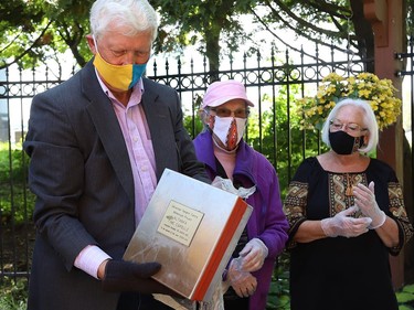 Ukrainian Seniors' Centre board member Taras Martyn and original Ukrainian Altanka Millennium Project committee members Mary Stefura, middle, and Sandra Sharko participated in the opening of a millennium time capsule at the Altanka (resting place) garden at the Ukrainian Seniors' Centre in Sudbury, Ont. on Friday September 11, 2020. The capsule, which was buried 20 years ago, contained a set of coins from the year 2000, newspaper clippings, photographs, documents, a small flag and pamphlets. The Altanka garden was a millennium gift to the Sudbury community from the Ukrainian community. John Lappa/Sudbury Star/Postmedia Network