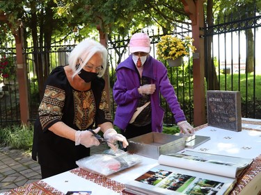 Original Ukrainian Altanka Millennium Project committee members Sandra Sharko, left, and Mary Stefura participated in the opening of a millennium time capsule at the Altanka (resting place) garden at the Ukrainian Seniors' Centre in Sudbury, Ont. on Friday September 11, 2020. The capsule, which was buried 20 years ago, contained a set of coins from the year 2000, newspaper clippings, photographs, documents, a small flag and pamphlets. The Altanka garden was a millennium gift to the Sudbury community from the Ukrainian community. John Lappa/Sudbury Star/Postmedia Network