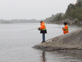 Leigh Channing and Bryan Loree fish in the rain near the boat launch on Ramsey Lake in Sudbury, Ont. on Tuesday September 15, 2020.