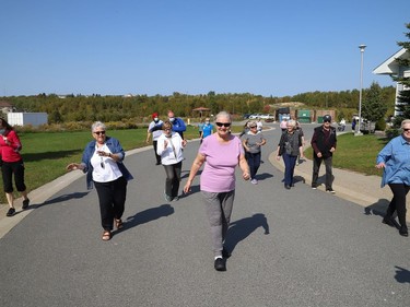 Finlandia Village townhouse residents and staff dance up and down a street at Finlandia in Sudbury, Ont. on Tuesday September 22, 2020. Fitness centre staff organized the event to provide residents with exercise and a social connection during the COVID-19 pandemic. John Lappa/Sudbury Star/Postmedia Network