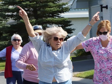 Eveline Brunet struts her stuff as Finlandia Village townhouse residents and staff dance up and down a street at Finlandia in Sudbury, Ont. on Tuesday September 22, 2020. Fitness centre staff organized the event to provide residents with exercise and a social connection during the COVID-19 pandemic. John Lappa/Sudbury Star/Postmedia Network