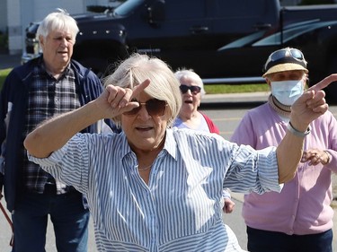 Eveline Brunet struts her stuff as Finlandia Village townhouse residents and staff dance up and down a street at Finlandia in Sudbury, Ont. on Tuesday September 22, 2020. Fitness centre staff organized the event to provide residents with exercise and a social connection during the COVID-19 pandemic. John Lappa/Sudbury Star/Postmedia Network