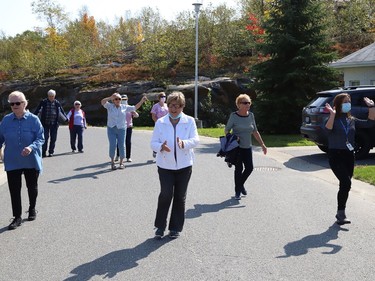 Finlandia Village townhouse residents and staff dance up and down a street at Finlandia in Sudbury, Ont. on Tuesday September 22, 2020. Fitness centre staff organized the event to provide residents with exercise and a social connection during the COVID-19 pandemic. John Lappa/Sudbury Star/Postmedia Network