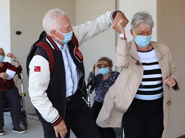 Maurice and Linda Obonsawin show off their dancing skills as Finlandia Village townhouse residents and staff dance up and down a street at Finlandia in Sudbury, Ont. on Tuesday September 22, 2020. Fitness centre staff organized the event to provide residents with exercise and a social connection during the COVID-19 pandemic. John Lappa/Sudbury Star/Postmedia Network