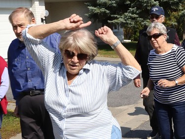 Eveline Brunet struts her stuff as Finlandia Village townhouse residents and staff dance up and down a street at Finlandia in Sudbury, Ont. on Tuesday September 22, 2020. Fitness centre staff organized the event to provide residents with exercise and a social connection during the COVID-19 pandemic. John Lappa/Sudbury Star/Postmedia Network