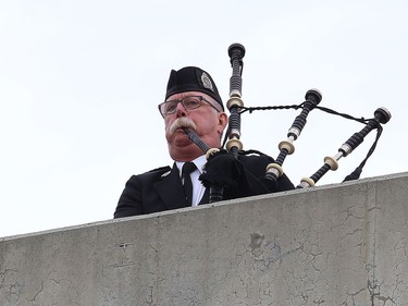 Greater Sudbury Police retired Staff Sgt. and pipe master Dave Linney plays the Piper's Lament at the Sgt. Frederick Davidson memorial bridge dedication ceremony on Wanup Pit Road near Highway 69 South on Thursday September 24, 2020. Davidson was killed in the line of duty in1937 after being shot multiple times. John Lappa/Sudbury Star/Postmedia Network