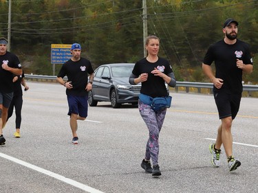 Members of the Greater Sudbury Police Run Club take part in the first leg of the virtual 460 kilometre Peace Officers' Memorial Run on Highway 69 in Sudbury, Ont. on Thursday September 24, 2020. The memorial run usually starts in Toronto and ends in Ottawa. National Peace Officers' Memorial Day is on September 27, 2020. The run began At the end of a bridge dedication ceremony for Sgt. Frederick Davidson who was killed in the line of duty in 1937. John Lappa/Sudbury Star/Postmedia Network